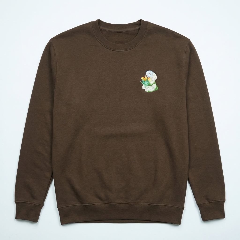 Brown sweatshirt with a small embroidered design on the chest against a light gray background